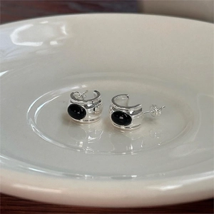 S925 sterling silver C-shaped hoop earrings with black oval onyx on white ceramic tray