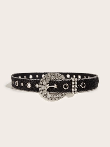 Detail of black glitter belt featuring a large rhinestone round buckle and metal eyelets