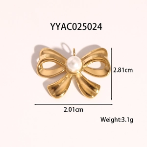 Macro shot of gold bow pendant with centered pearl inlay and detailed dimensions