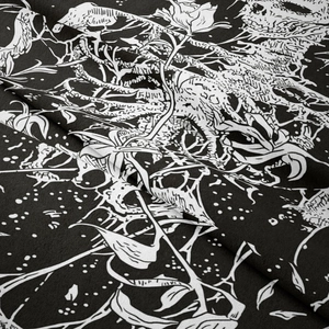 Close-up of gothic skull and rose fabric texture with high contrast black and white prints