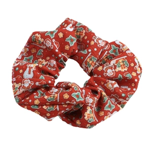 Red Christmas scrunchie with festive Santa and snowman prints on cotton twill fabric