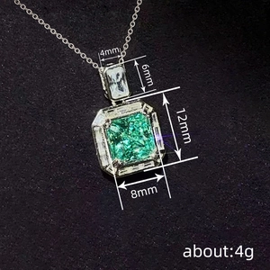 Elegant emerald-cut green gemstone necklace with square zircons on velvet background