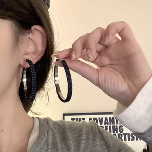Exaggerated geometric round hoop earrings in dark blue denim fabric with silver needle