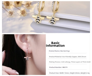 Detailed view of gold-plated bee earrings with white and black cubic zirconia stones