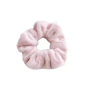 Soft pink plush scrunchie hair tie for women made of fluffy faux fur material