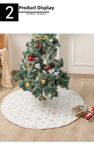 Detail of white plush Christmas tree skirt with golden snowflake patterns and center opening