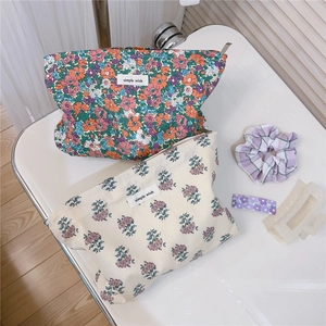 Two vintage floral cotton makeup bags with colorful flower patterns and zipper