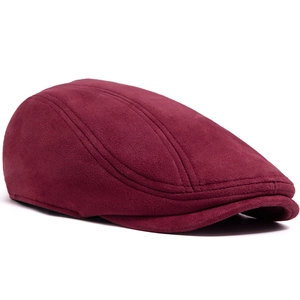Close-up of burgundy suede flat cap showing fine texture and decorative stitching