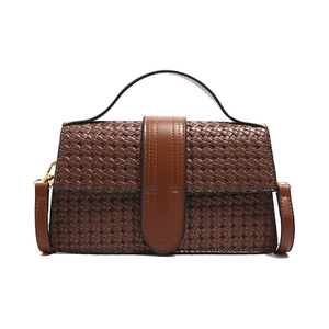 Classic dark brown woven texture handbag with top handle and gold hardware crossbody strap