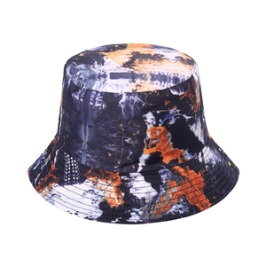 Women's reversible floral bucket hat with abstract black and orange tie-dye pattern