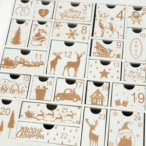 Detail of wooden Christmas advent calendar with 24 drawers featuring festive gold patterns