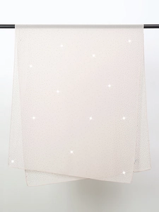 Detail of elegant beige chiffon shawl with shimmering starry sky rhinestone accents