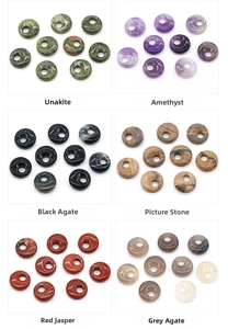 Macro shot of 18mm natural gemstone donut pendants in six assorted crystal materials