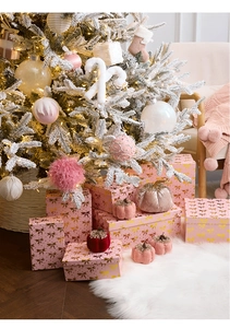 Pink velvet decorative pumpkins and luxury gift boxes near snowy Christmas tree