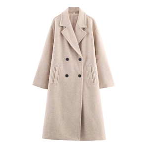 Detail of oatmeal wool coat featuring notch lapels and double-breasted buttons