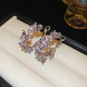 Silver needle hoop earrings with purple zircon butterflies and elegant crystal details