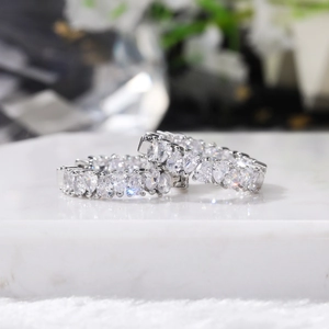 Macro detail of silver hoop earrings featuring marquise-cut AAA cubic zirconia stones