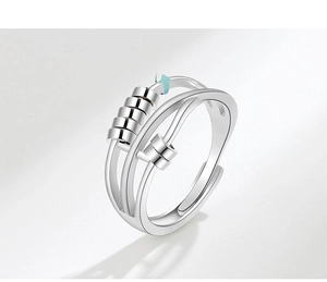 Detailed view of silver anxiety ring with rotating beads and adjustable open band