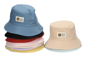 Detail of multi-color cotton bucket hats showing reinforced stitching and brand woven label