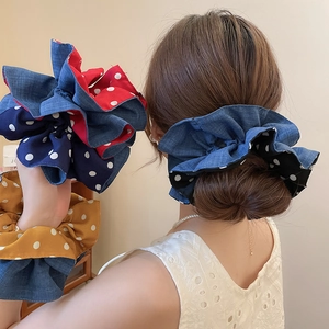 Close-up of polka dot fabric and denim texture on double-layered scrunchies