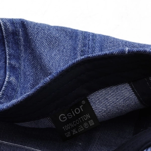 Detail of Gsior denim hat inner washing label showing 100% cotton fabric and care icons