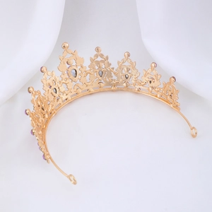Detailed close-up of vintage golden crown with purple gemstones and ornate alloy patterns