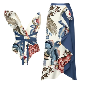 Detail of ruffled one-shoulder bikini top and tropical parrot print sarong skirt