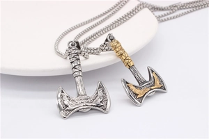 Detailed close-up of Viking double eagle axes in silver and gold steel finishes