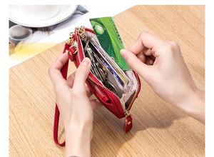 Close-up of red pebbled leather coin purse showing interior card slots and key chain