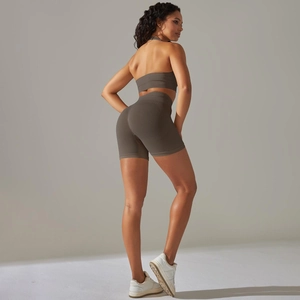 Detail of dark brown seamless ribbed yoga set with high-waist shorts and sports bra