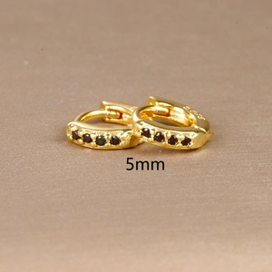 Macro shot of gold S925 sterling silver hoop earring with black zircon inlay and 5mm mark