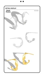Detailed close-up of twisted S925 sterling silver hoop earrings in gold and silver