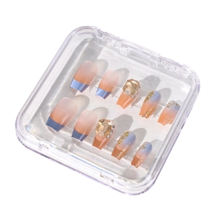 Clear display box with gradient rhinestone press-on nails and sparkling gold glitter