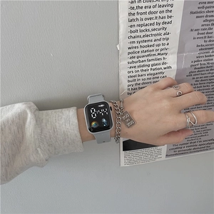 Grey square LED digital watch paired with silver chain bracelet and rings for urban styling