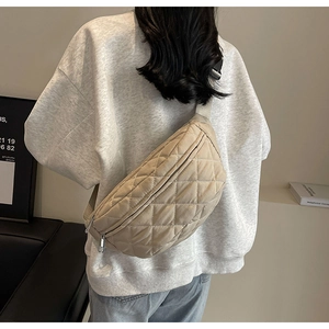 Close-up of beige quilted crossbody chest bag with elegant diamond pattern stitching