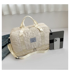 Close-up of beige travel bag with star embossing and separate shoe compartment