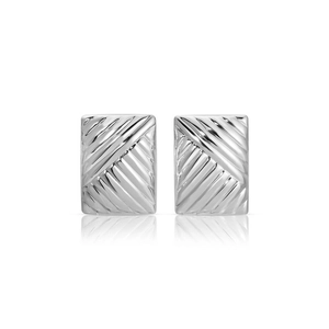 Macro view of silver rectangular earrings with diagonal twill pattern and polished finish