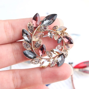 Macro shot of gold floral brooch featuring amber crystals and marquise stones