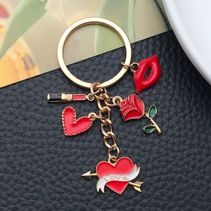 Detail of red enamel charms including lips, rose and heart with LOVE text on gold keychain