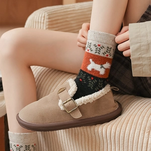 Close-up of vintage wool socks with cute dog patterns and plush slippers with metal buckle
