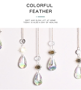Close-up of teardrop crystal suncatcher with metal sun charm and AB iridescent finish