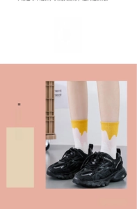 Close-up of yellow, white, and pink gradient crew socks with black platform sneakers
