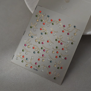 Detail of Christmas nail stickers with gold vines and colorful rhinestones Co-491