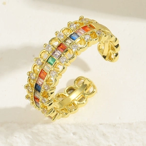 Macro detail of gold open ring with colorful zircon gems and intricate lace cutout patterns