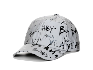 Detail of silver reflective baseball cap featuring black graffiti text and metallic finish