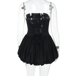 Detail of black strapless mini dress featuring a lace-up back and bubble hemline design