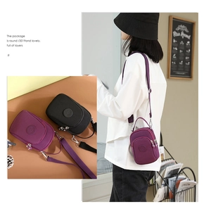 Detail of multi-layer nylon crossbody bag featuring adjustable straps and dual color options