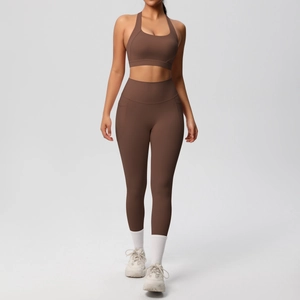 Close-up of brown yoga set featuring a halter sports bra and leggings with side pockets