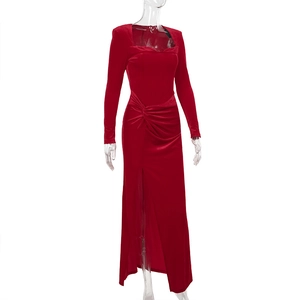 Detail of red velvet dress featuring an elegant square neckline and twisted waist knot