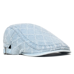 Detail of light blue denim beret with vintage lattice pattern and bronze metal buckle